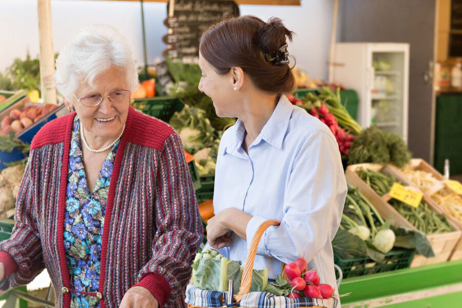 Caregiver shopping with elderly woman