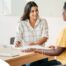 A woman smiles while being interviewed representing how well a caregiver interview can go when good questions are asked.