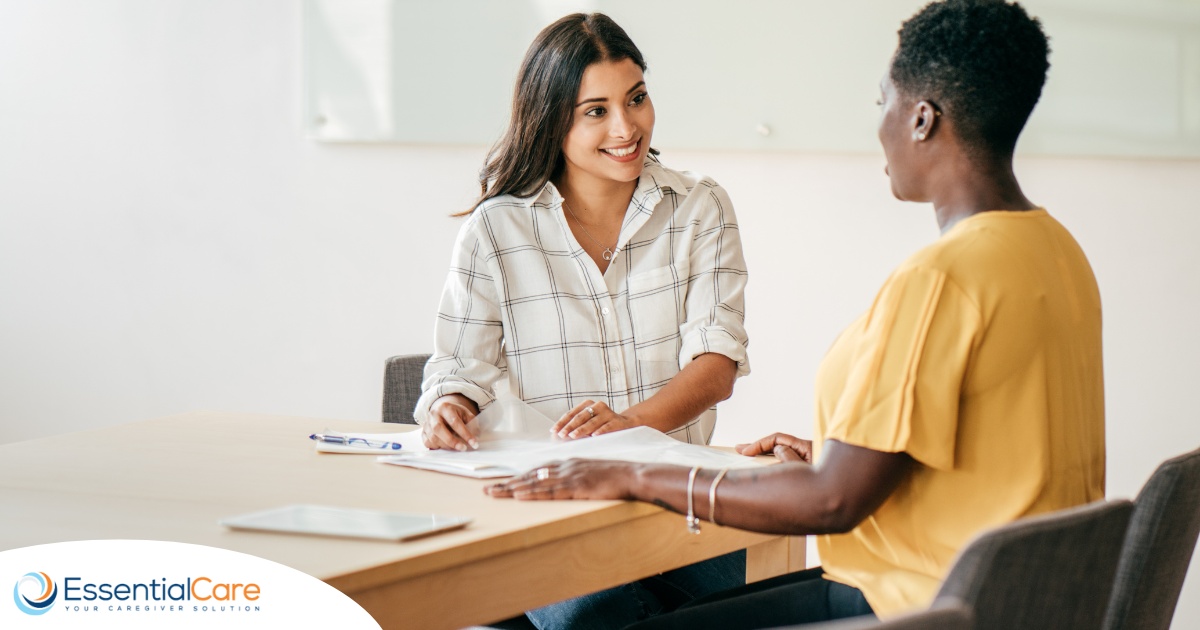 A woman smiles while being interviewed representing how well a caregiver interview can go when good questions are asked.