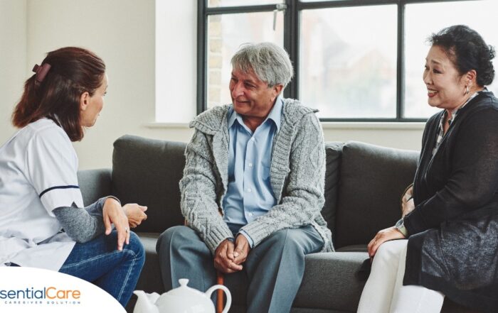 A caregiver talks with an elderly couple representing the kind of communication that professional caregivers need to have to anticipate client needs.