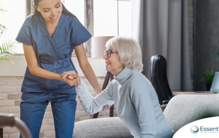 A caregiver demonstrates her caregiver skills by helping an older adult get up.