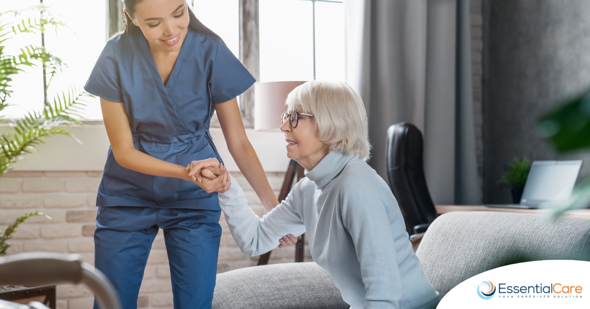 A caregiver demonstrates her caregiver skills by helping an older adult get up.
