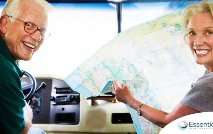 An older couple looks back smiling from the front of an RV, representing how day trips for seniors can help boost the mood of everyone.