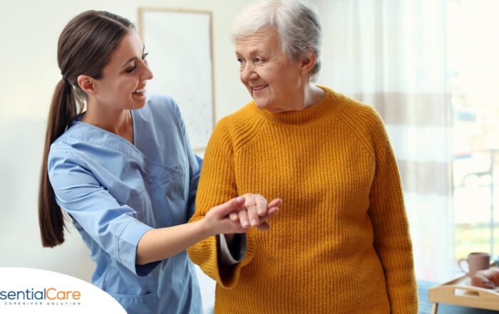 A caregiver helps a client get around, demonstrating one of the job duties of a caregiver.