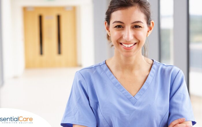 A woman in scrubs smiles, representing the good results that can come when caregivers branch out to become CNAs.