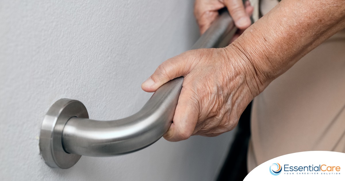 An older adult uses a grab bar representing one of the home modifications that is helpful for fall prevention for elderly adults.