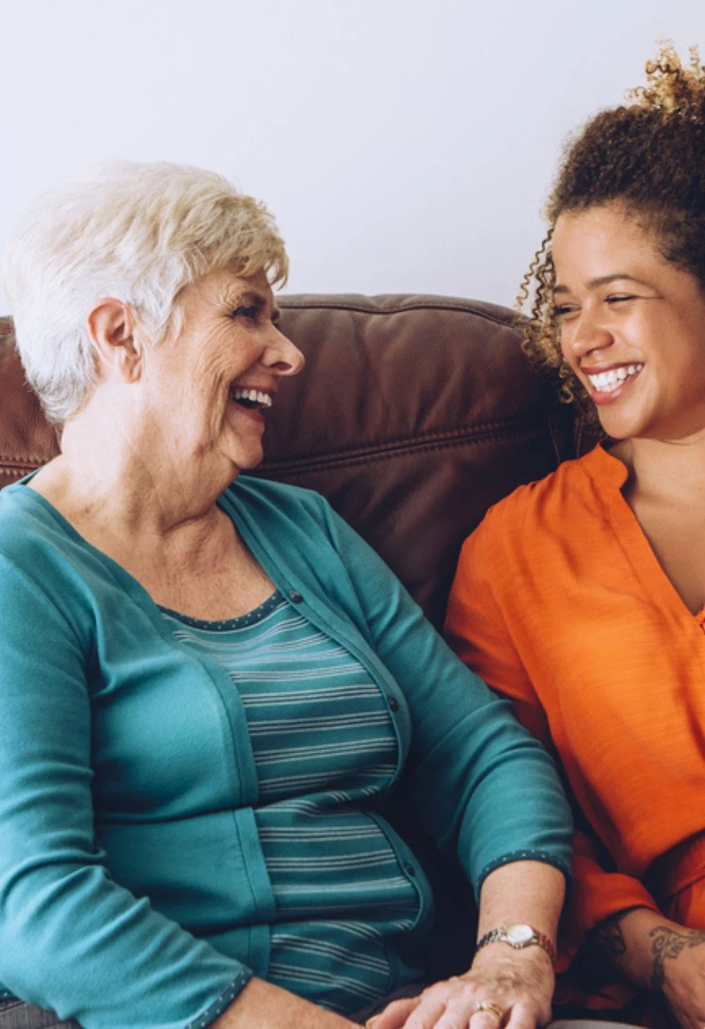 Caregiver smiling and talking with an elderly woman, representing compassionate senior care for Mesquite residents